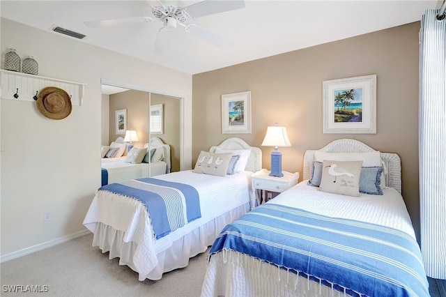 carpeted bedroom with a closet and ceiling fan