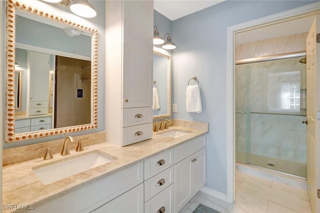 737 Wiggins Lake Dr Unit 201, Naples, FL 34110 - bathroom featuring a stall shower, double vanity, marble look tiles, and baseboards
