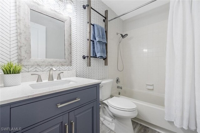 full bathroom featuring shower / bath combo, toilet, wood-type flooring, and vanity