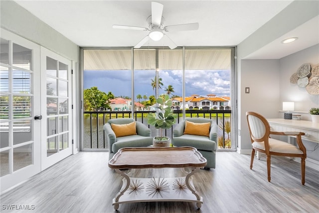 sunroom / solarium with french doors and ceiling fan