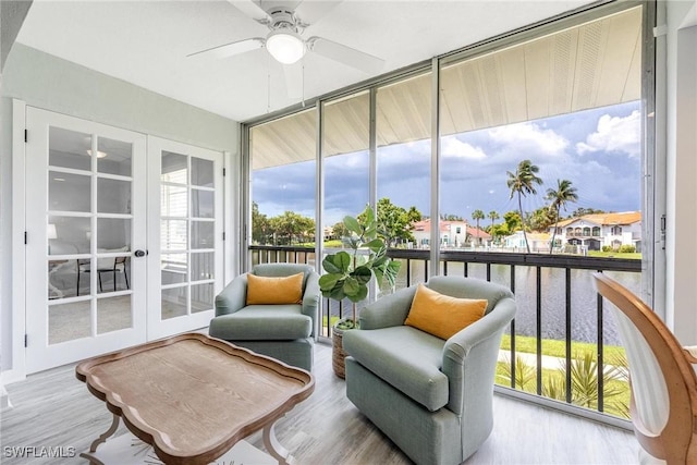 sunroom featuring french doors and ceiling fan