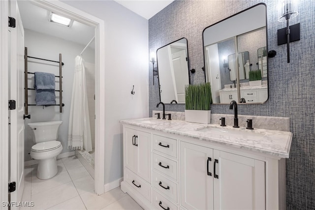 bathroom featuring toilet, a shower with curtain, vanity, and tile patterned floors