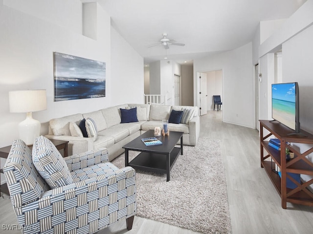 living room with light wood-type flooring and ceiling fan