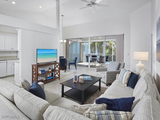 living room with light hardwood / wood-style flooring, high vaulted ceiling, and ceiling fan