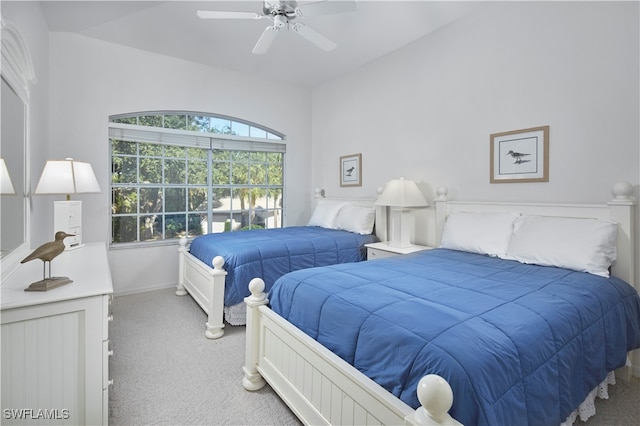 bedroom featuring carpet flooring, vaulted ceiling, and ceiling fan