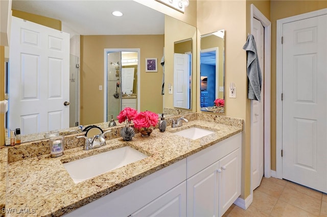 bathroom featuring double sink vanity and tile patterned flooring