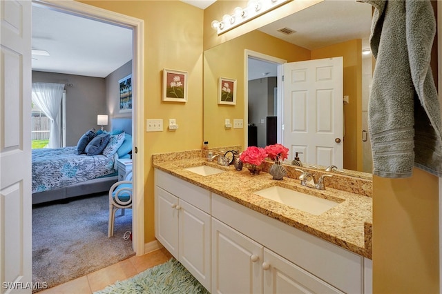 bathroom with tile patterned flooring and dual vanity