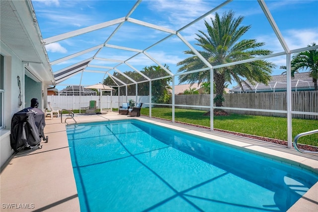 view of swimming pool with a grill, a lanai, a yard, and a patio