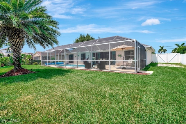 back of house with a patio, a yard, a lanai, and a fenced in pool