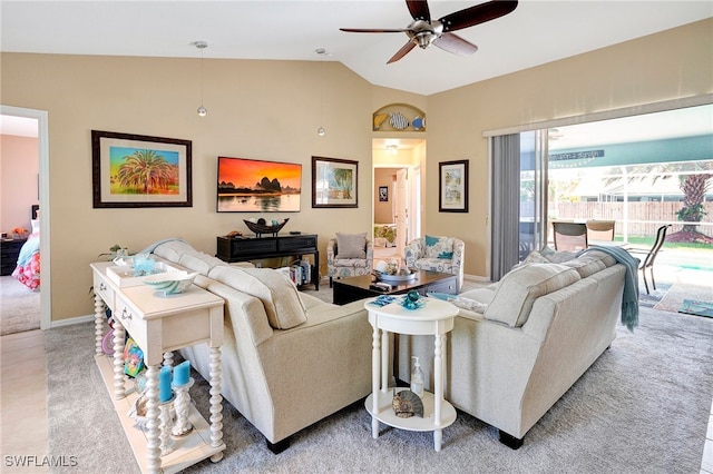 living room featuring ceiling fan, lofted ceiling, and light colored carpet