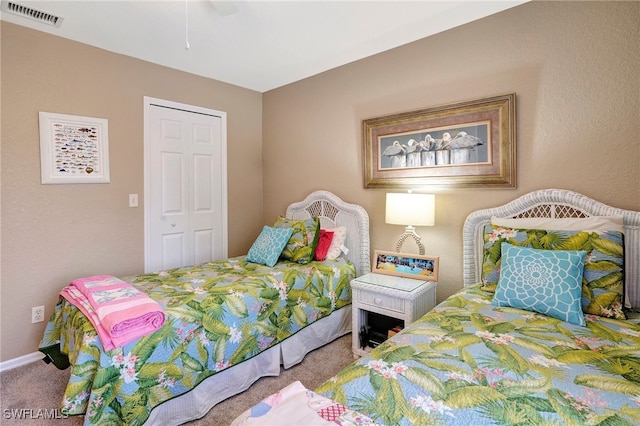 carpeted bedroom with ceiling fan and a closet