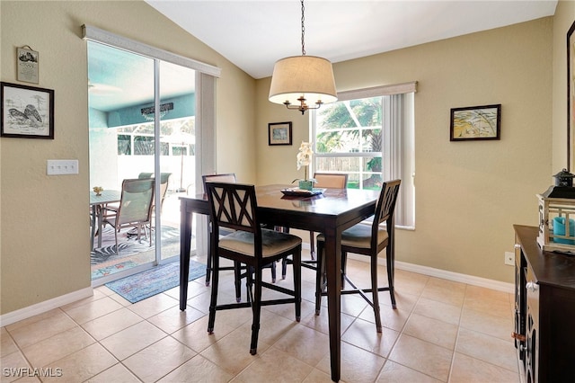 tiled dining room with vaulted ceiling