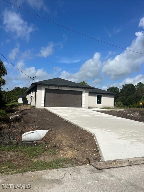 view of front of home with a garage and an outdoor structure