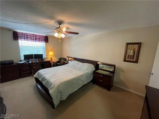 bedroom with ceiling fan, a textured ceiling, and light colored carpet