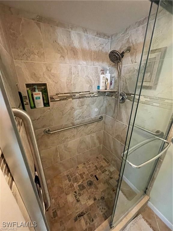 bathroom featuring walk in shower and tile patterned flooring