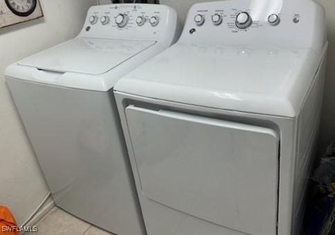 4210 Steamboat Bnd Unit 405, Fort Myers, FL 33919 - laundry room with washing machine and clothes dryer, light tile patterned floors, and baseboards