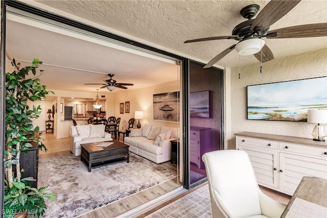4210 Steamboat Bnd Unit 405, Fort Myers, FL 33919 - living area with a ceiling fan, a textured ceiling, and light wood finished floors