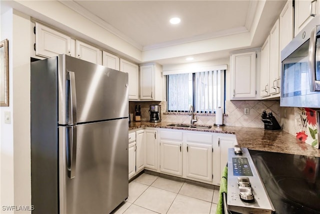 4210 Steamboat Bnd Unit 405, Fort Myers, FL 33919 - kitchen featuring appliances with stainless steel finishes, a sink, tasteful backsplash, light tile patterned floors, and ornamental molding