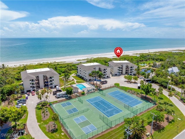 aerial view with a water view and a beach view