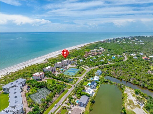 bird's eye view featuring a water view and a beach view