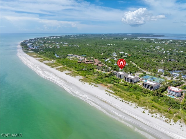 birds eye view of property featuring a beach view and a water view