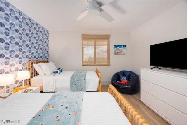 bedroom with ceiling fan and light hardwood / wood-style flooring