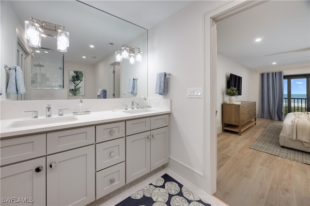 bathroom with vanity, hardwood / wood-style flooring, and walk in shower