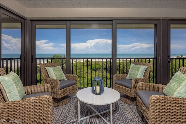 sunroom / solarium with wooden ceiling and a water view