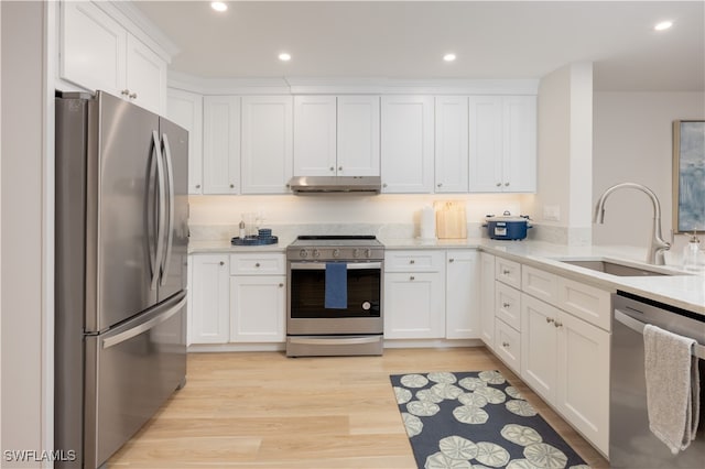 kitchen featuring light hardwood / wood-style flooring, white cabinets, stainless steel appliances, and sink