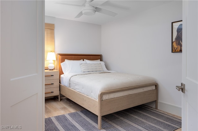 bedroom with light hardwood / wood-style flooring and ceiling fan