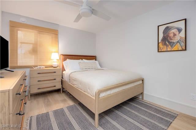 bedroom with ceiling fan and light hardwood / wood-style floors