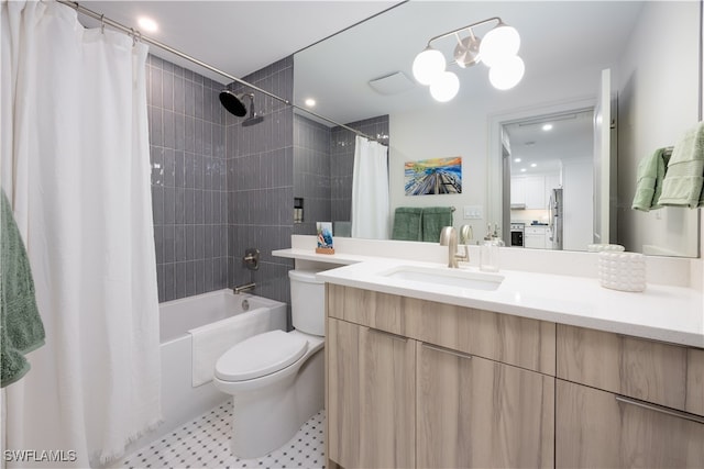 full bathroom with vanity, toilet, an inviting chandelier, and shower / bath combo with shower curtain