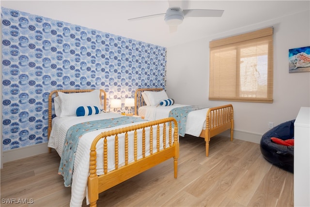 bedroom featuring ceiling fan and light hardwood / wood-style flooring