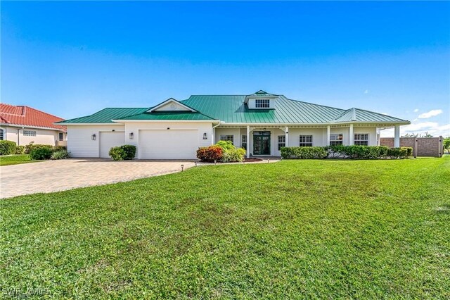 view of front of home featuring a garage and a front lawn