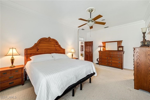 carpeted bedroom with ceiling fan and ornamental molding