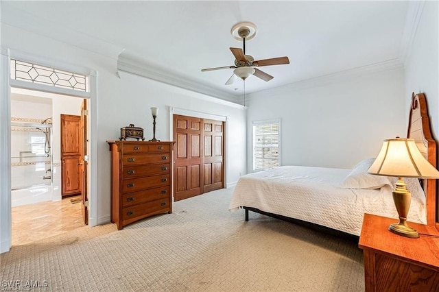 carpeted bedroom with ensuite bathroom, a closet, ceiling fan, and ornamental molding