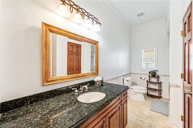 bathroom with tile patterned floors, vanity, tile walls, toilet, and ornamental molding