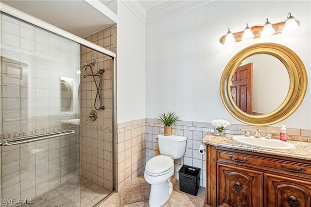 bathroom featuring tile patterned floors, tile walls, toilet, a shower with shower door, and ornamental molding