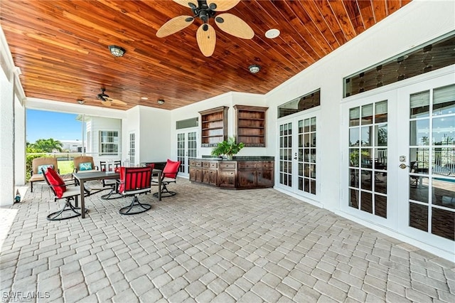 view of patio featuring ceiling fan and french doors