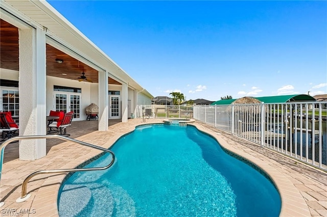 view of pool with ceiling fan, an in ground hot tub, french doors, and a patio