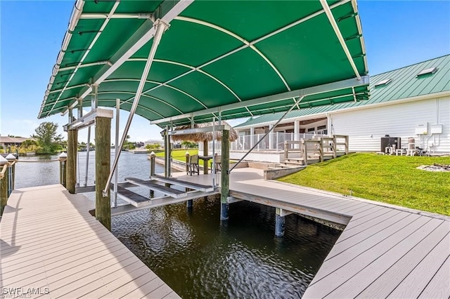 view of dock with cooling unit, a water view, and a lawn