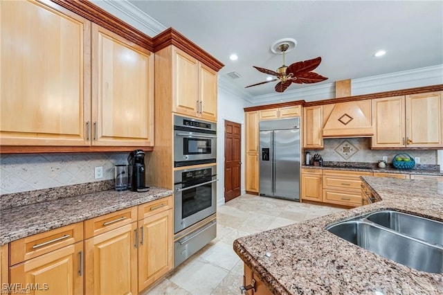 kitchen featuring crown molding, backsplash, and appliances with stainless steel finishes