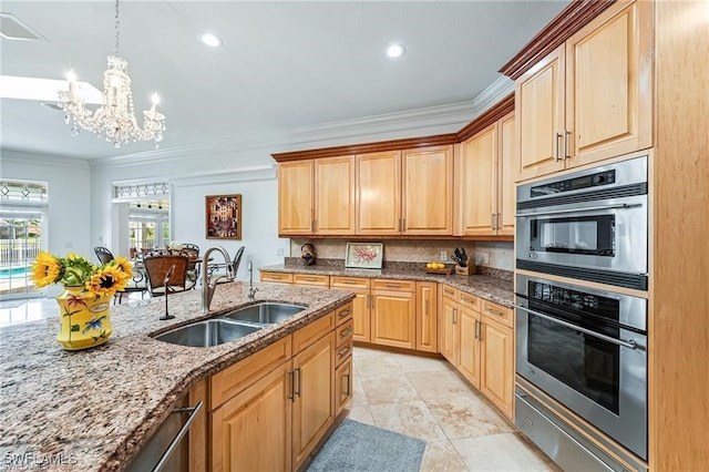 kitchen with stainless steel double oven, sink, hanging light fixtures, ornamental molding, and light stone counters