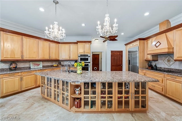 kitchen featuring stainless steel appliances, decorative backsplash, pendant lighting, and an island with sink