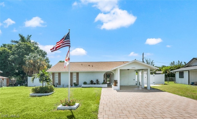 view of front of property with a front yard and a carport