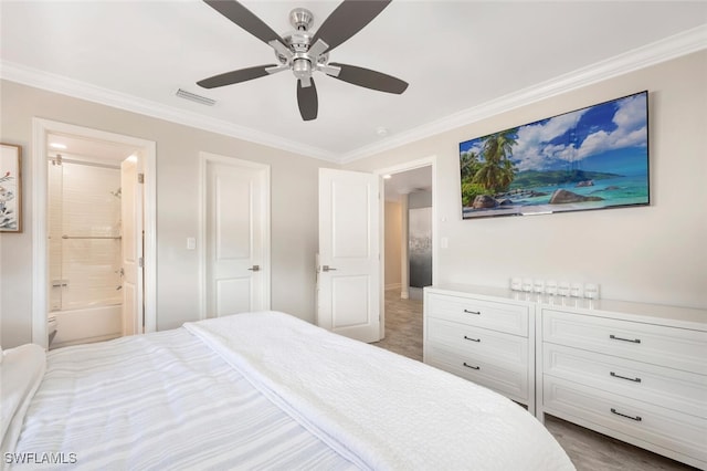 bedroom with ceiling fan, ensuite bath, and crown molding