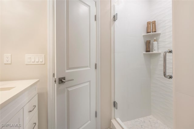 bathroom with vanity and a shower with shower door