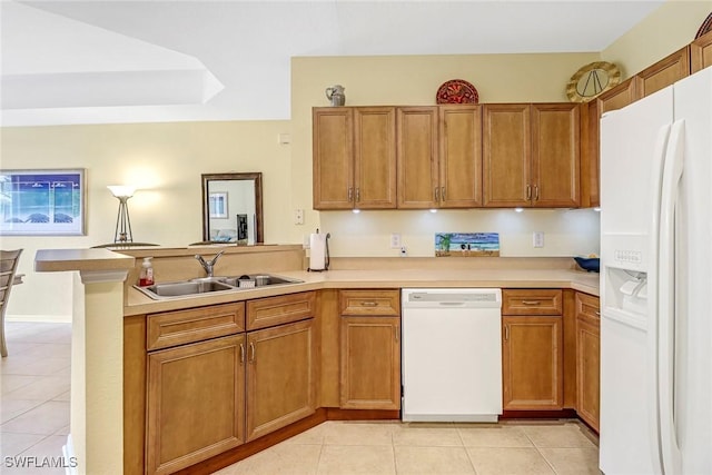 kitchen featuring sink, white appliances, kitchen peninsula, and light tile patterned floors