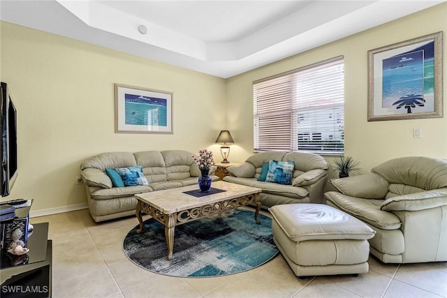 tiled living room featuring a raised ceiling