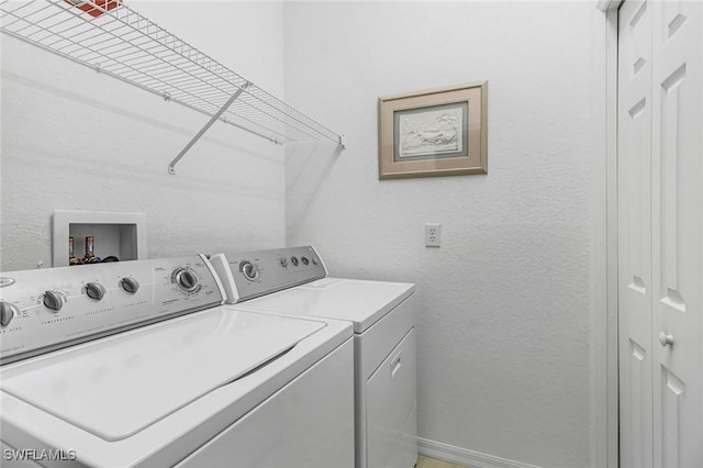 clothes washing area with separate washer and dryer